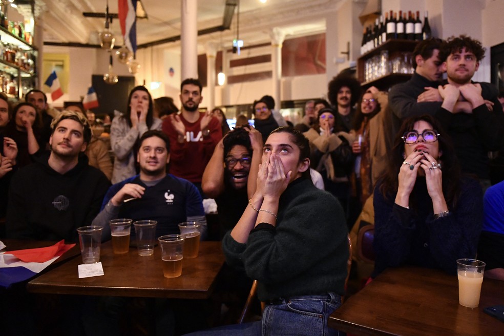 Torcedores reagem ao final da partida entre Argentina e França em um bar perto da Praça da República, em Paris — Foto: JULIEN DE ROSA / AFP