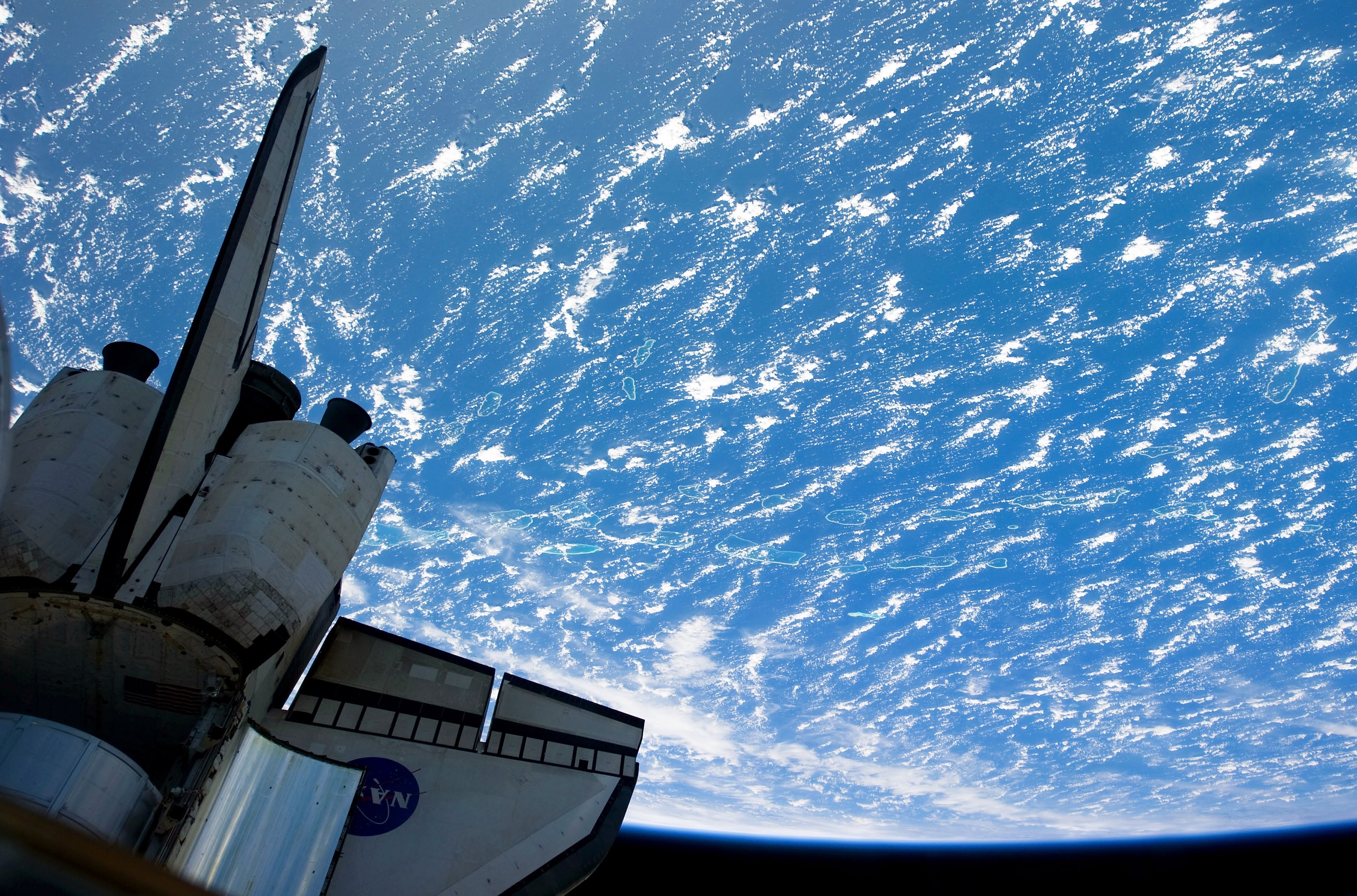 26 de fevereiro de 2011 - Nesta imagem fornecida pela NASA, as partes azul e branca da Terra ao fundo e a seção traseira do ônibus espacial Discovery, ancorado na ISS, em primeiro plano. (Foto: Getty Images)