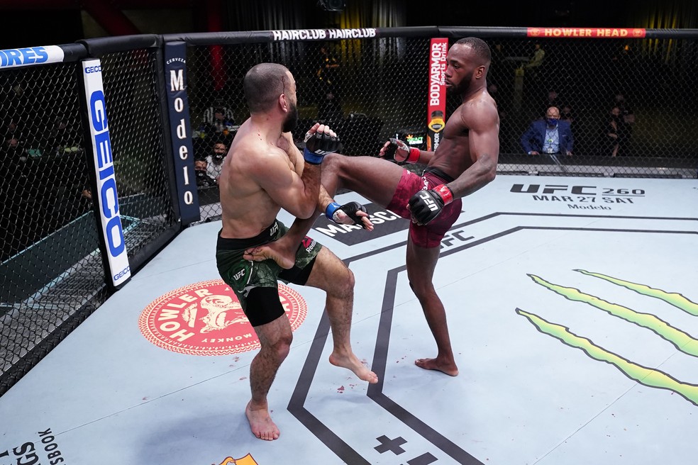 Leon Edwards acerta um chute logo após tocar o olho de Belal Muhammad com o dedo — Foto: Getty Images