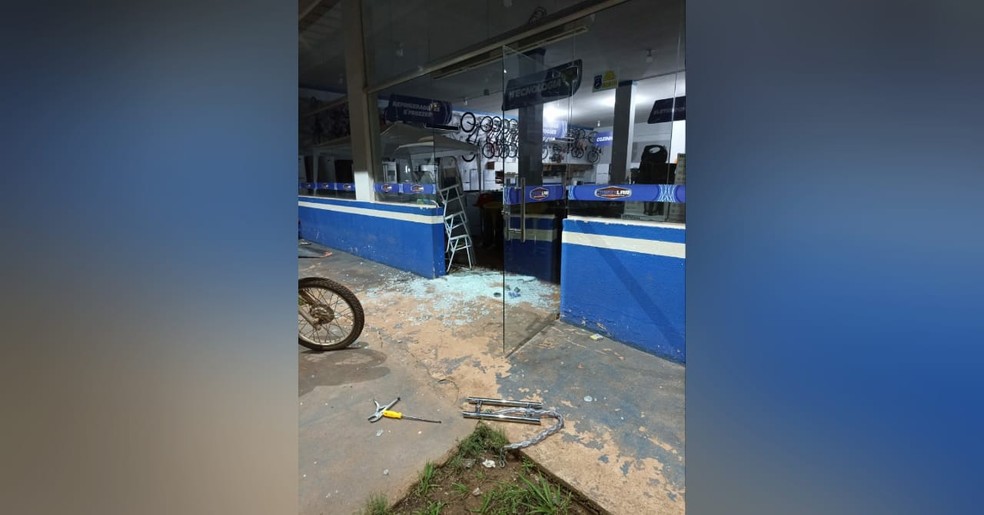 A porta de vidro principal da loja que foi quebrada durante o ato criminoso — Foto: Reprodução/Redes Sociais