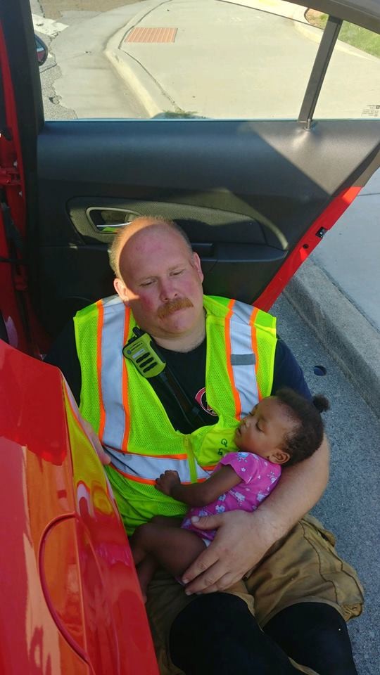 O capitão Chris com a bebê em seus braços enquanto a confortava (Foto: Reprodução Facebook)