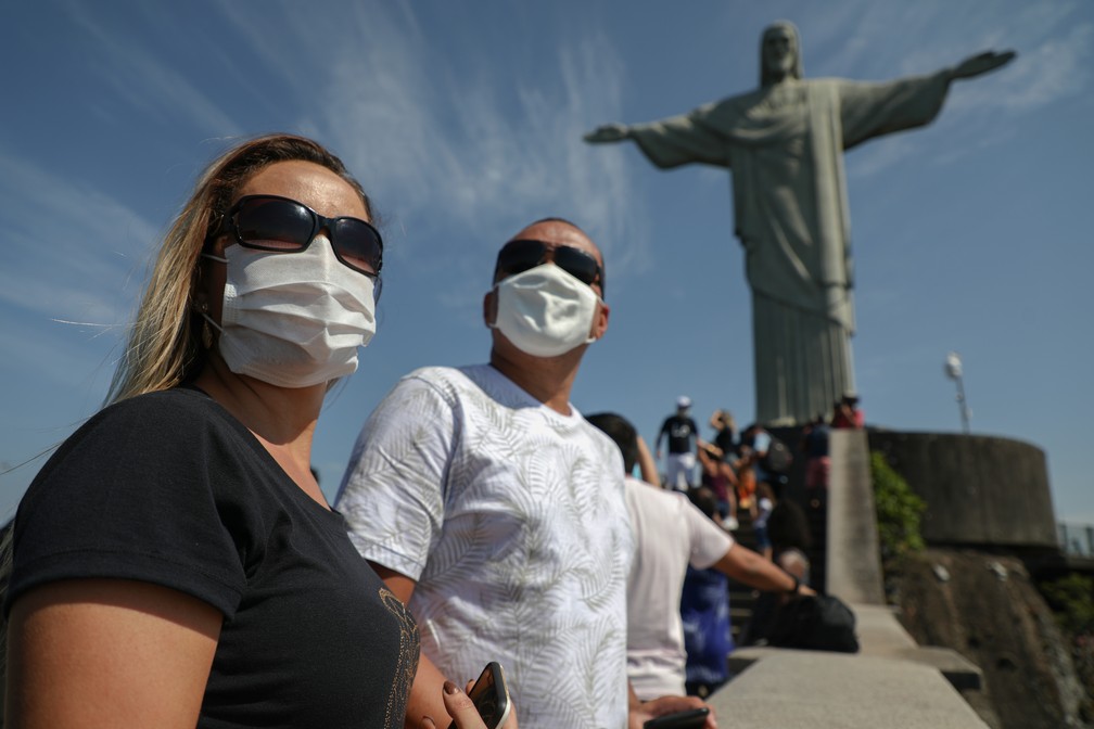 Foto mostra casal visitando o Cristo Redentor, no Rio de Janeiro, no dia 15 de agosto, dia de reabertura das atrações turísticas na cidade. — Foto: Fabio Motta/AFP