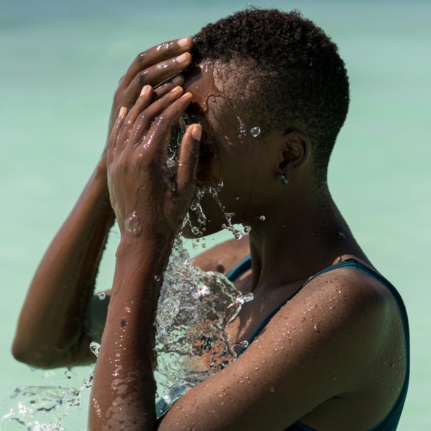 Black skin girl in turquoise water (Foto: Getty Images)