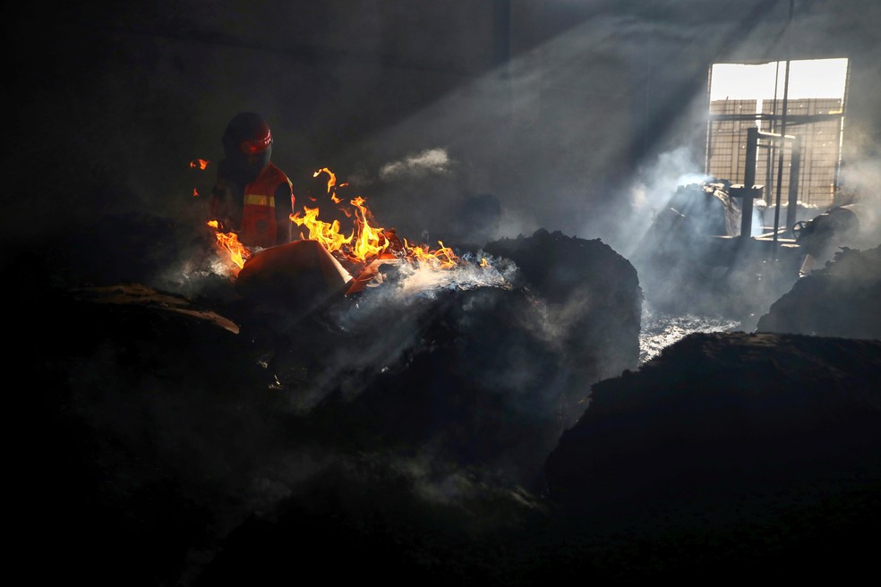 Bombeiro tenta extinguir incêndio dentro do prédio de fábrica em Rupganj, nos arredores de Daca, capital de Bangladesh, em 9 de julho de 2021 — Foto: Mohammad Ponir Hossain/Reuters