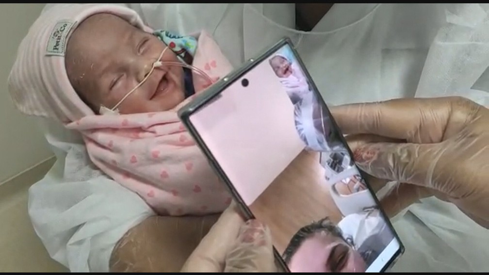 Luiza sorri ao ouvir a voz da mãe pelo tablet — Foto: Reprodução/TV Globo