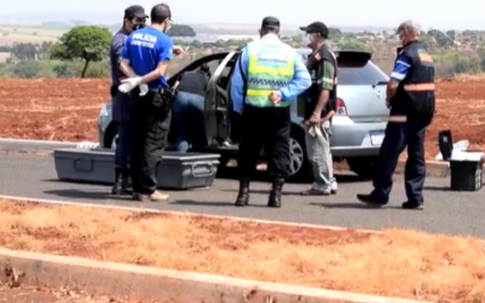 Perícia sendo feita em carro onde pai e filho adolescente foram mortos a tiros em Quirinópolis  — Foto: Reprodução/TV Anhanguera