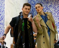 Klebber Toledo e Camila Queiroz acenam para paparazzo em aeroporto no Rio
