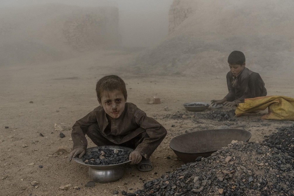 Meninos trabalham em fábrica de tijolos nos arredores de Cabul — Foto: Ebrahim Noroozi/ AP