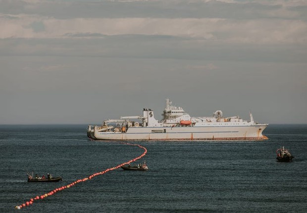 Pequenos barcos guiam o cabo de volta até a costa para a transmissão dos dados de internet (Foto: Google Cloud/Divulgação)