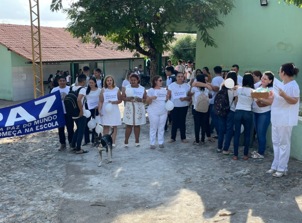 Os professores usam branco e fizeram uma faixa com palavras de paz e recomeço. — Foto: Mateus Ferreira/Sistema Verdes Mares