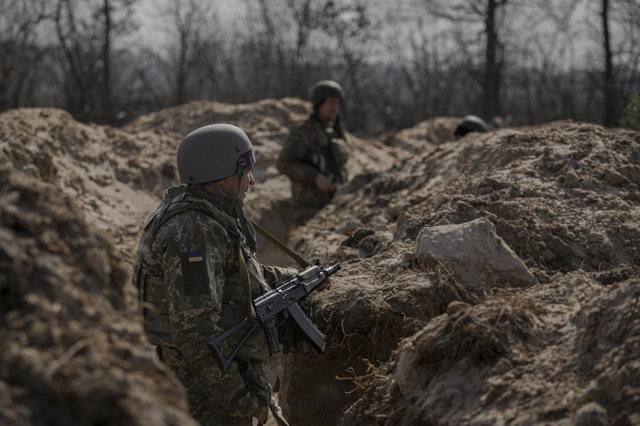 Ukrainian servicemen stand in trenches at a position north of the capital Kyiv, Ukraine, Tuesday, March 29, 2022. The first face-to-face talks in two weeks between Russia and Ukraine began Tuesday in