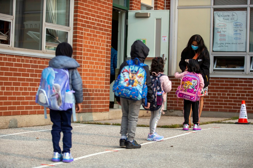 Crianças chegam para o primeiro dia de aulas desde o início da pandemia de Covid-19 em Scarborough, na província de Ontário, no Canadá, nesta terça-feira (15). — Foto: Carlos Osorio/Reuters