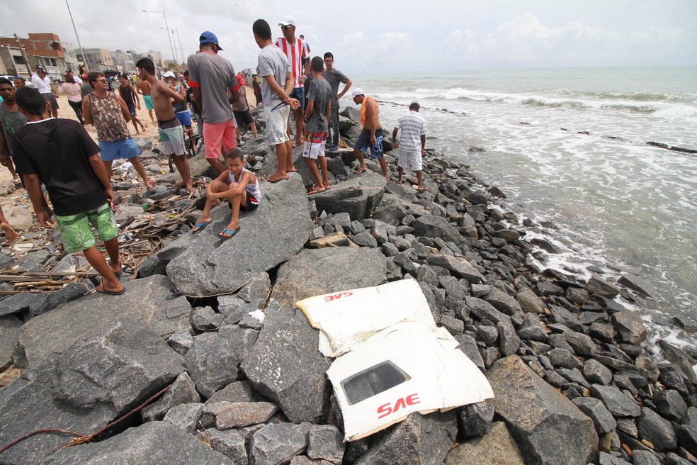 Partes da fuselagem do Globocop estão sendo retiradas do mar (Foto: Ado Carneiro/Pernambuco Press)