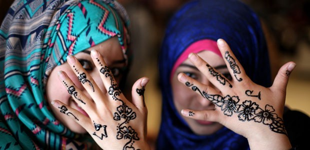 Palestinas mostram mãos pintadas com hena na Cidade de Gaza, em março de 2014 (Foto: Mohammed Abed/AFP)