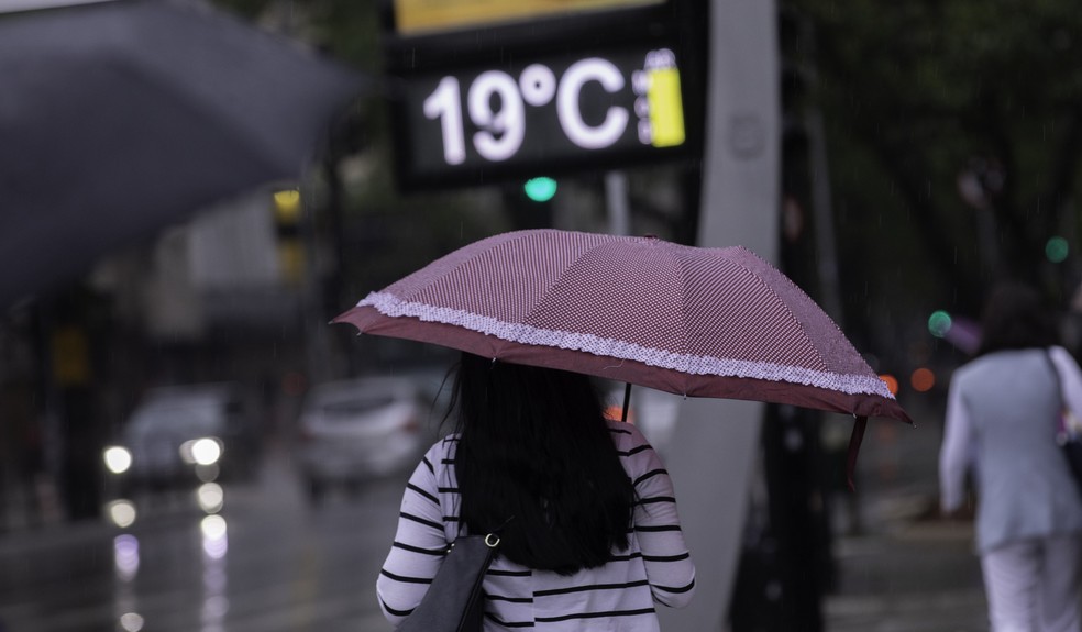  Pessoas caminham e se protegem da chuva no Viaduto Santa Generosa, zona sul de São Paulo, na manhã desta sexta-feira (09) — Foto: Bruno Rocha/FotoArena via Estadão Conteúdo