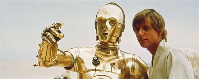 O robô humanoide C-3PO ao lado de Luke Skywalker, "no filme "Guerra nas Estrelas"