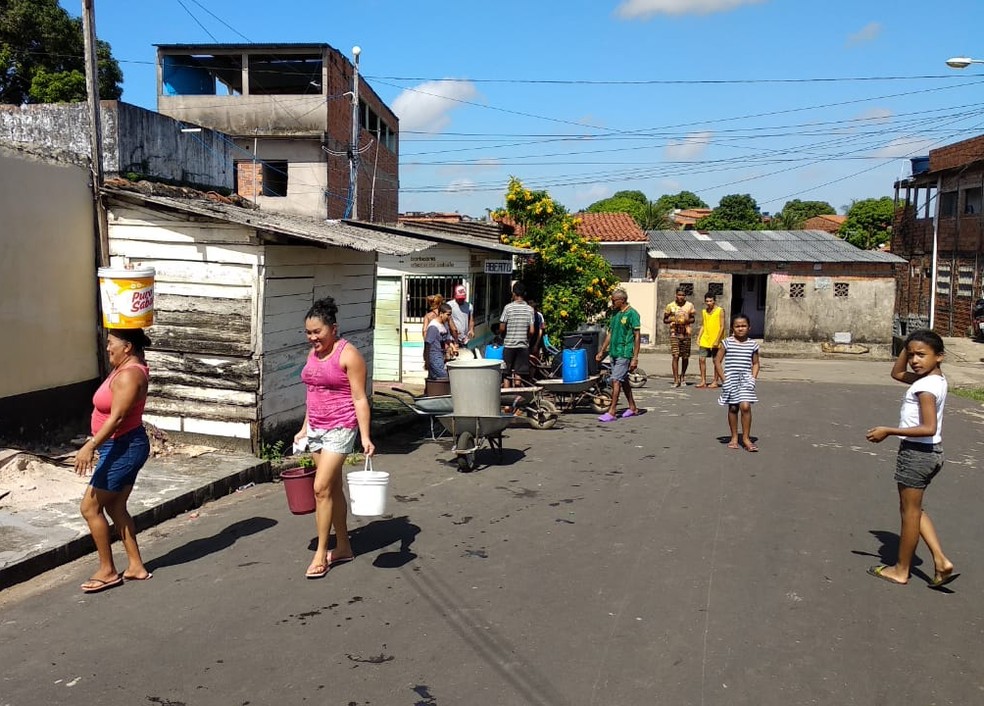 Moradores no Anjo da Guarda abastecendo casas com baldes — Foto: Douglas Pinto / TV Mirante