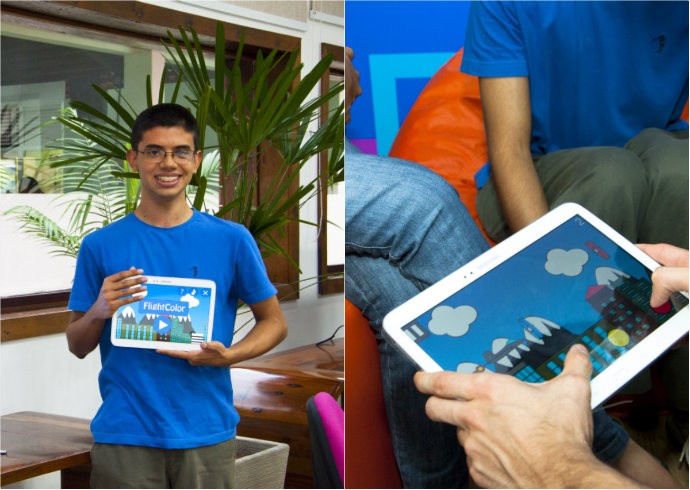 Criador e obra. Jovem segura tablet com o seu jogo rodando (Foto: Reprodução/JoelmaSanmelo)