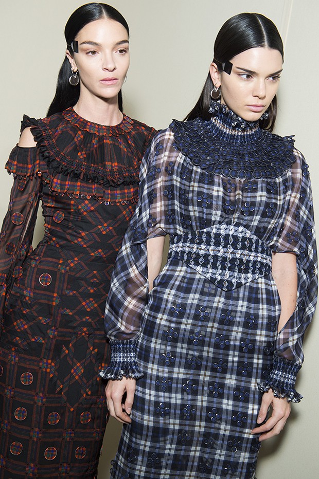 Mariacarla Boscono (left) wears a Givenchy Haute Couture silk chiffon tartan-print dress with hand-pleated neck, cuffs, and hem; embellished with thin chiffon-covered metal disks. Matched with a printed jersey lace-encrusted jumpsuit. Kendall Jenner wears a silk-chiffon tartan-print dress with hand-smocked neck, waist, and wrists; embellished all over with small, graduated metal, chiffon-covered disks worn with a printed jersey lace-encrusted jumpsuit. (Foto: Givenchy)