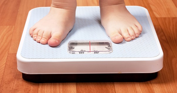 Criança pesando em balança (Foto: Shutterstock)