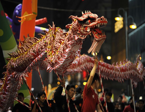Participantes da festa de Ano Novo Lunar chinês fazem a dança do dragão, nas ruas de Hong Kong. (Foto: Antony Dickson/AFP Photo)