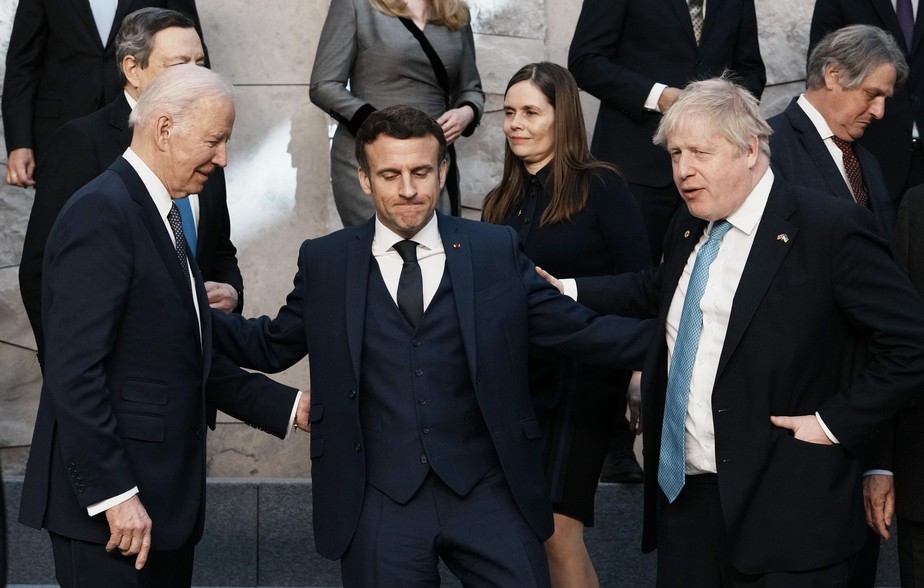 U.S. President Joe Biden, left, French President Emmanuel Macron, center, and British Prime Minister Boris Johnson speak prior to a group photo during an extraordinary NATO summit at NATO headquarters