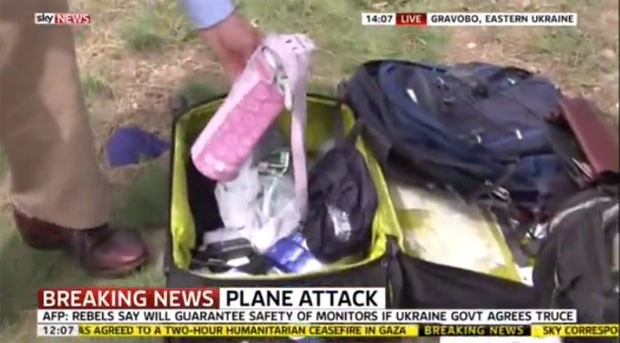 Repórter da rede britânica Sky News mostra itens que estavam em bagagem de uma das vítimas do voo MH17, que caiu na Ucrânia (Foto: Reprodução/YouTube/London&#39;s News Videos)