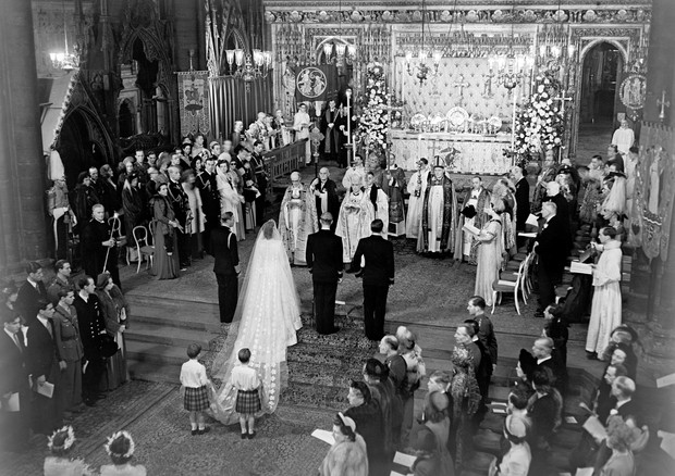 The scene at the altar steps during the Royal Wedding Ceremony in Westminster Abbey. H.M the King stands to the left of the bride; on the bridegroom's right is the groomsman, the Marques of Milford Haven. The bride's train is held by two pages T.R.H Princ (Foto: PA Archive/PA Images)