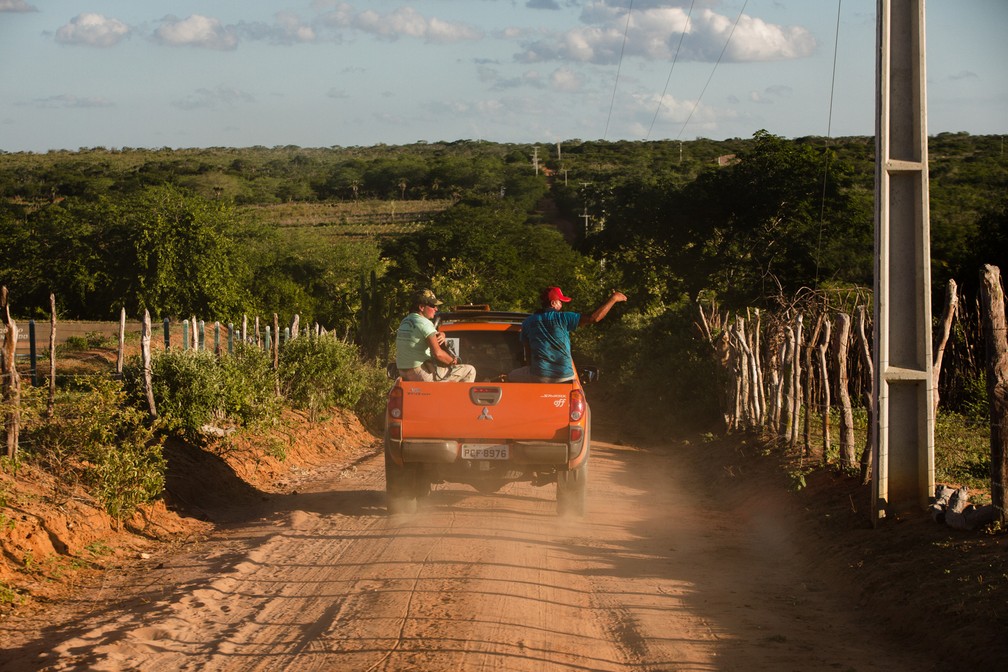 Agricultores locais passam pro estrada de terra no meio de propriedades rurais na região de Jeremoabo, na Bahia — Foto: Marcelo Brandt/G1