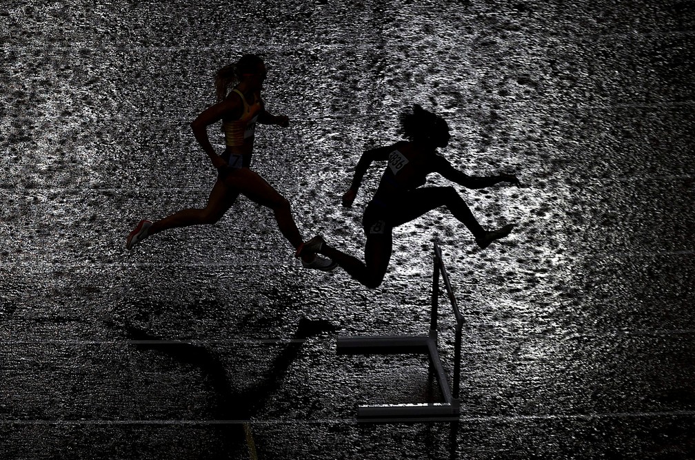 2 de agosto - A forte chuva foi mais um obstáculo na semifinal feminina dos 400m com barreira no Estádio Olímpico de Tóquio — Foto: Hannah Mckay/Reuters