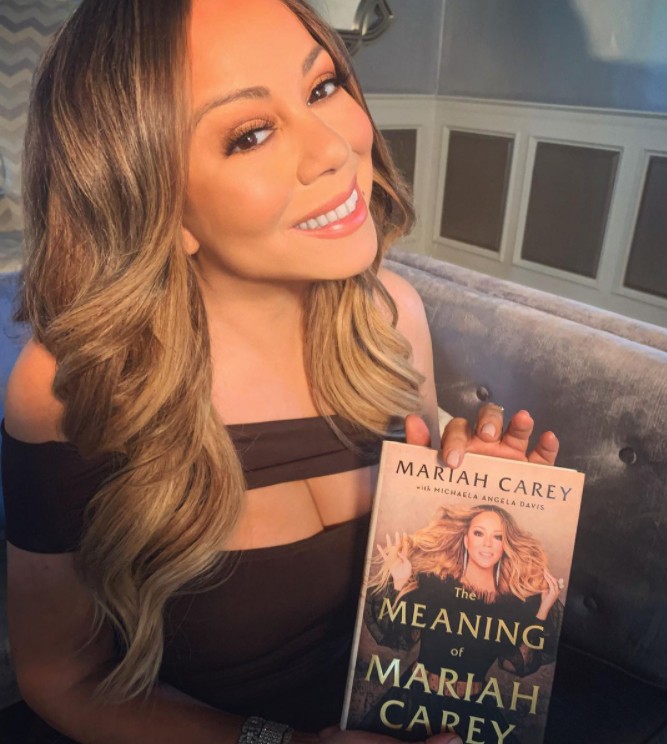 Mariah Carey com sua autobiografia, The Meaning of Mariah Carey (Foto: Reprodução / Instagram)