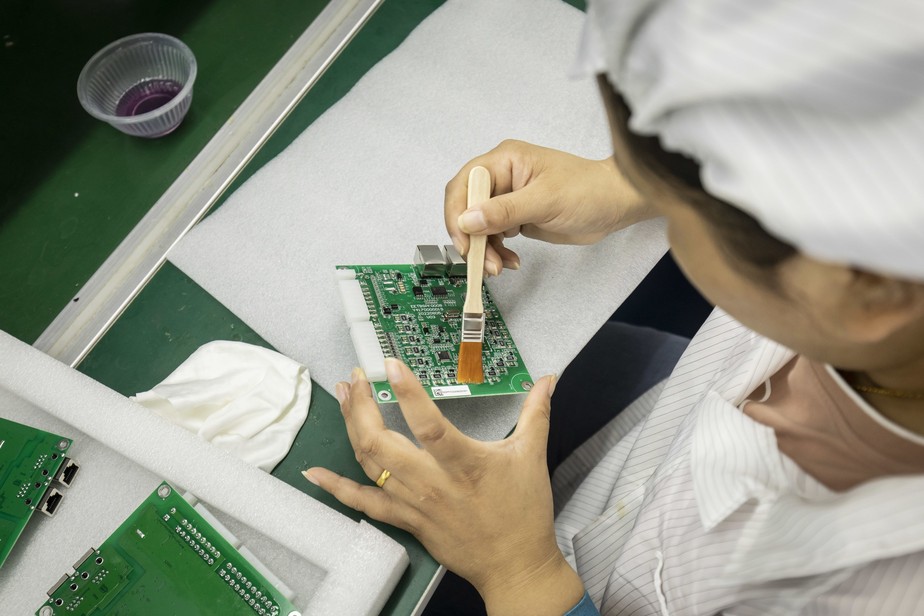 Uma funcionária em uma fábrica de produção de placas em Suzhou, na China