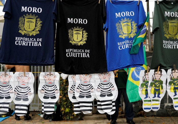 Ambulante vende camisetas de apoio ao juiz Sérgio Moro e bonecos do ex-presidente Luiz Inácio Lula da Silva vestido de presidiário (Foto: Nacho Doce/Reuters)