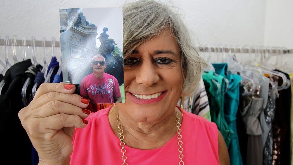 Afrodite com uma foto do período anteiror ao se assumir como crossdresser (Foto: Alair Ribeiro/BBC Brasil)
