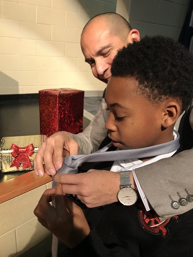 Voluntário ensina menino a dar nó de gravata (Foto: Reprodução Twitter @DISDPD_AChiefJR)
