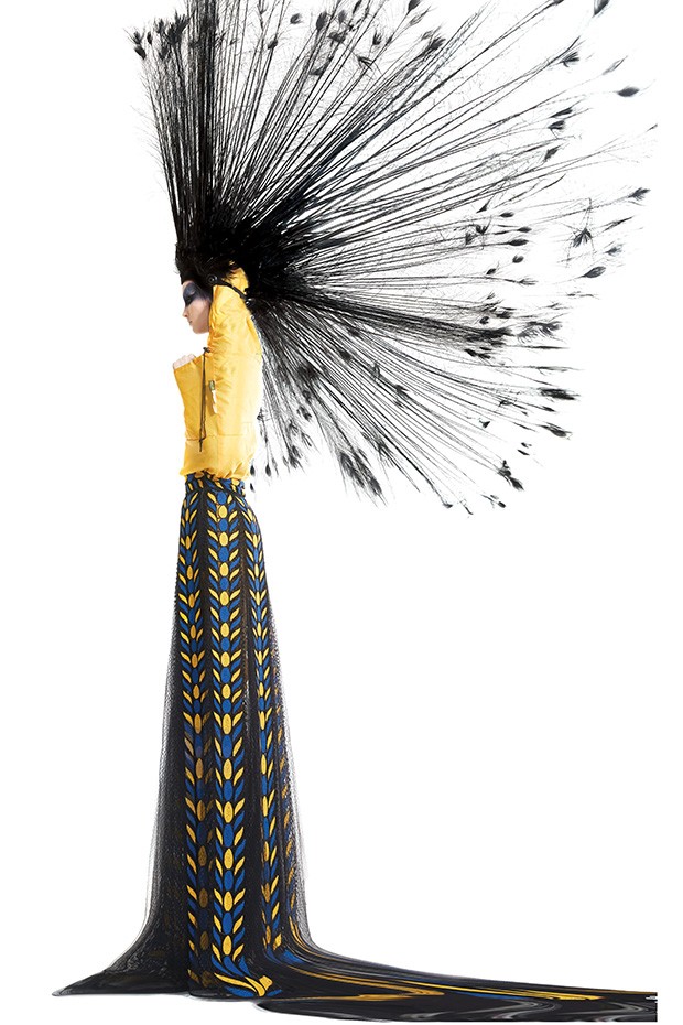 A model wears a Stephen Jones headpiece of burnt peacock and ostrich spines for Marc Jacobs’ final show for Louis Vuitton, Spring/Summer 2014. 