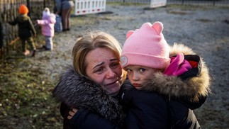 Svetlana Titova, 52, abraça sua neta ao chegar da cidade russa de Berdyansk, em um centro de ajuda humanitária na cidade ucraniana central de Zaporizhzhia — Foto: ANATOLII STEPANOV/AFP