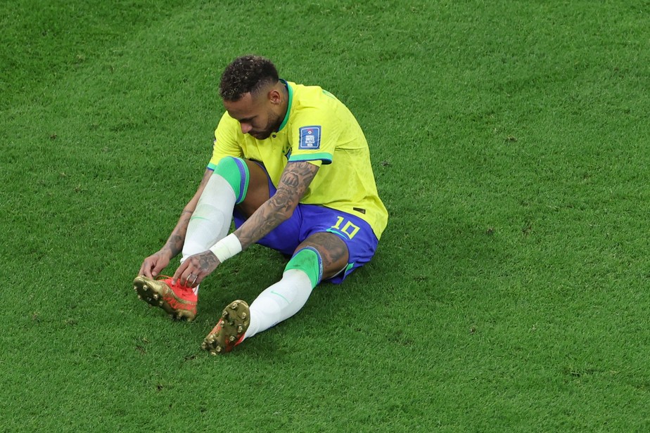 Neymar leva a mão ao tornozelo direito logo antes de pedir substituição, na estreia do Brasil contra Gana