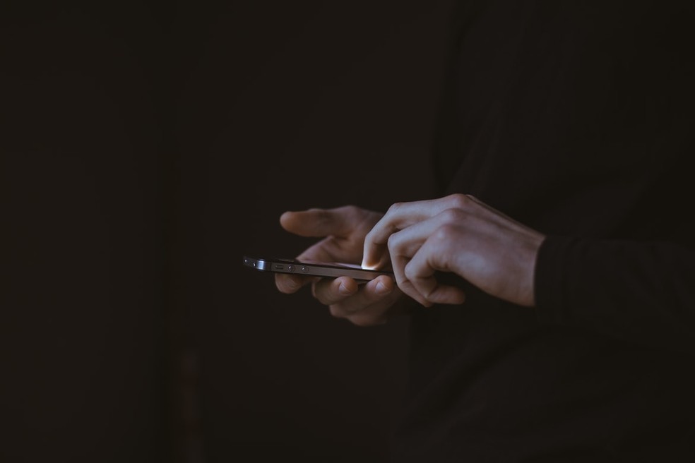  Homem usa aplicativo de namoro em celular  — Foto:  Gilles Lambert / Unsplash