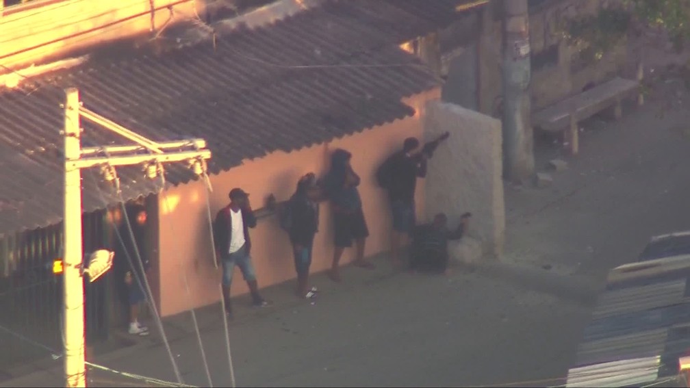 Bandidos se enfileiram atrás de barreira na Cidade de Deus — Foto: Reprodução/TV Globo