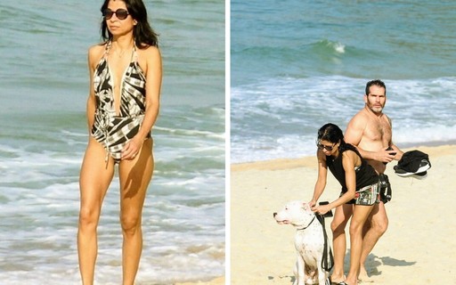Anna Lima vai à praia acompanhada do namorado e dá mergulho com cachorro