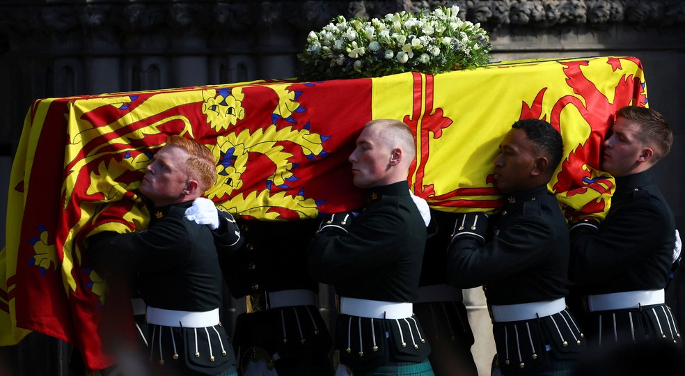 Oficiais fardados carregam o caixão com o corpo da rainha Elizabeth II para dentro de Saint Giles — Foto: Hannah McKay/REUTERS