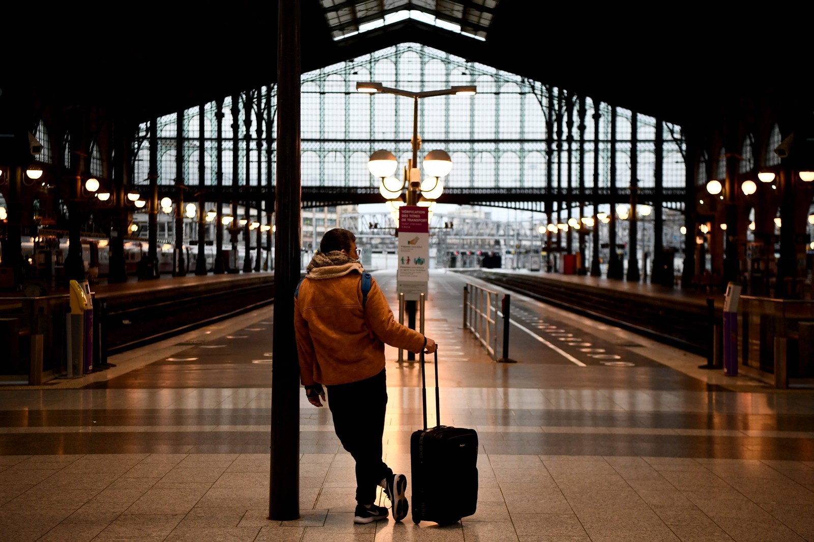 Viajante espera em frente às plataformas da estação de trem Gare du Nord em Paris em um novo dia de greves e protestos nacionais contra reforma da previdência — Foto: CHRISTOPHE ARCHAMBAULT/AFP