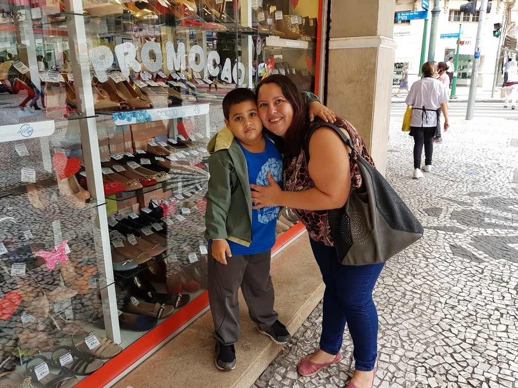 Marta Reis veio até a Rua XV de Novembro, no Centro de Curitiba, com filho Leonardo — Foto: Natalia Filippin/G1