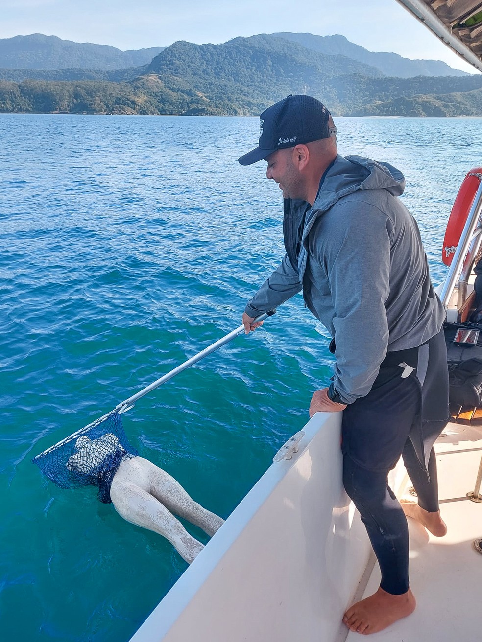 Pesquisador retira manequim do mar em Ilhabela — Foto: Divulgação
