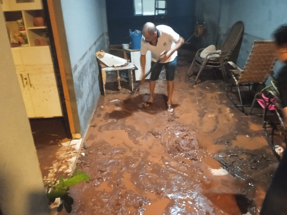 Morador tenta retirar lama após chuva, em Nova Esperança — Foto: Corpo de Bombeiros/Divulgação